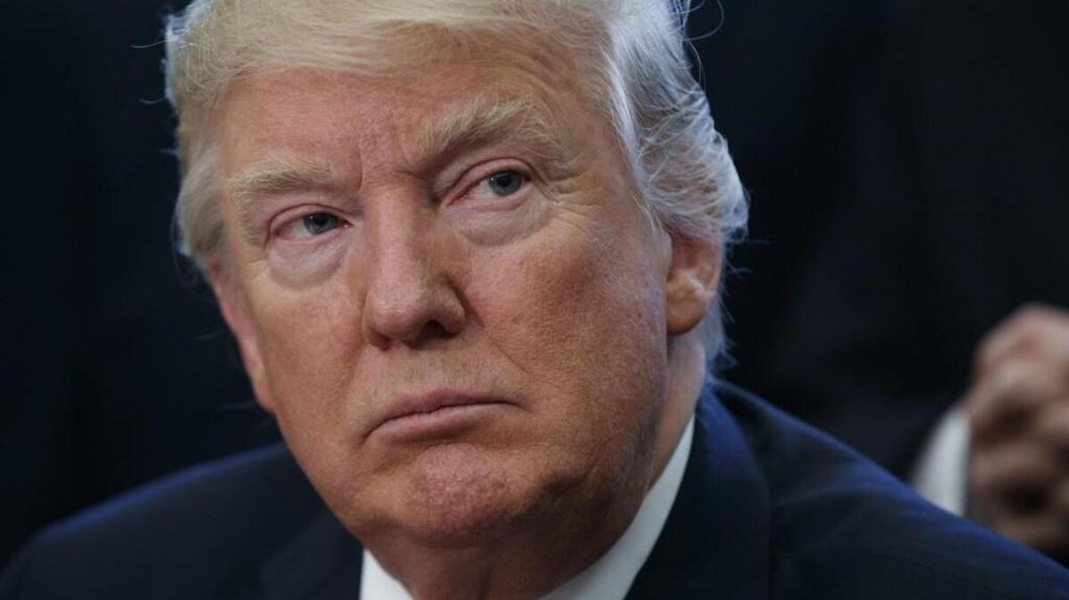 President Donald Trump listens to speakers in the Oval Office of the White House in Washington Tuesday during a signing ceremony for a bill to increase NASA’s budget