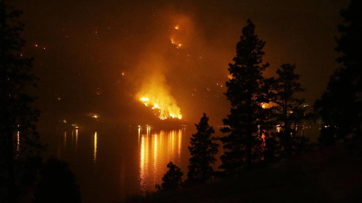 
Timber burns in the First Creek fire near lakeside structures on the western shore of Lake Chelan late Monday, near Lake Chelan State Park. That park, and two others, have been closed because of wildfires.
