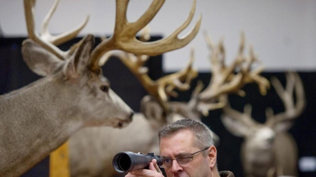 Chris Chojnowski of Tacoma checked out a rifle scope at the booth of Nitu Company Performance Optics at the 2011 Washington Sportsmen's Show. This year’s show opens Jan. 25.