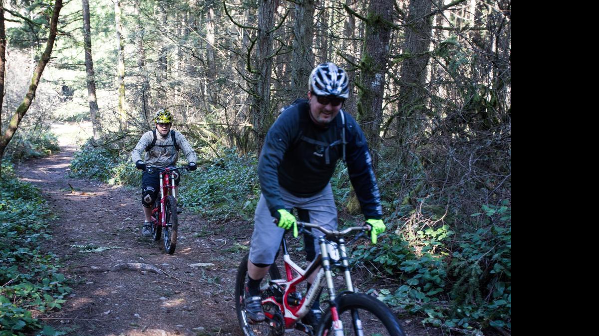 
Two men test out Swan Creek Park's mountain bike trails in 2014. The bike trails will be the location of a kids mountain biking camp this summer. 
