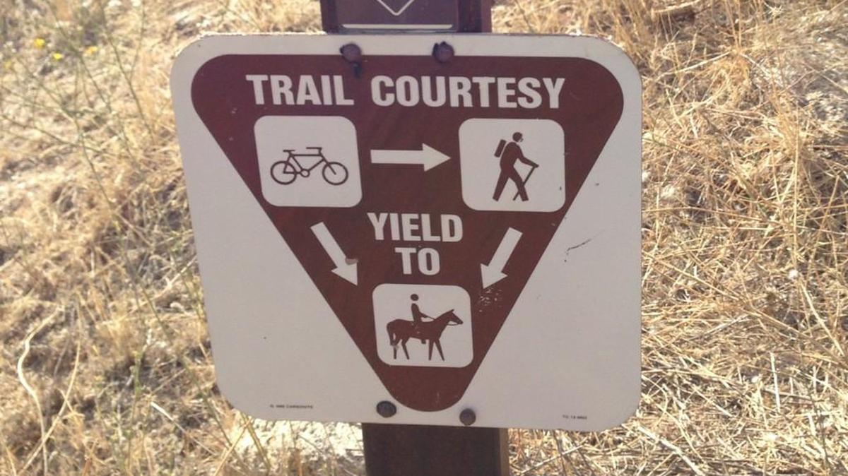 A sign on a trail system in Boise explains who has the right of way on trails. Everybody yields to horses. Bikes yield to everybody.