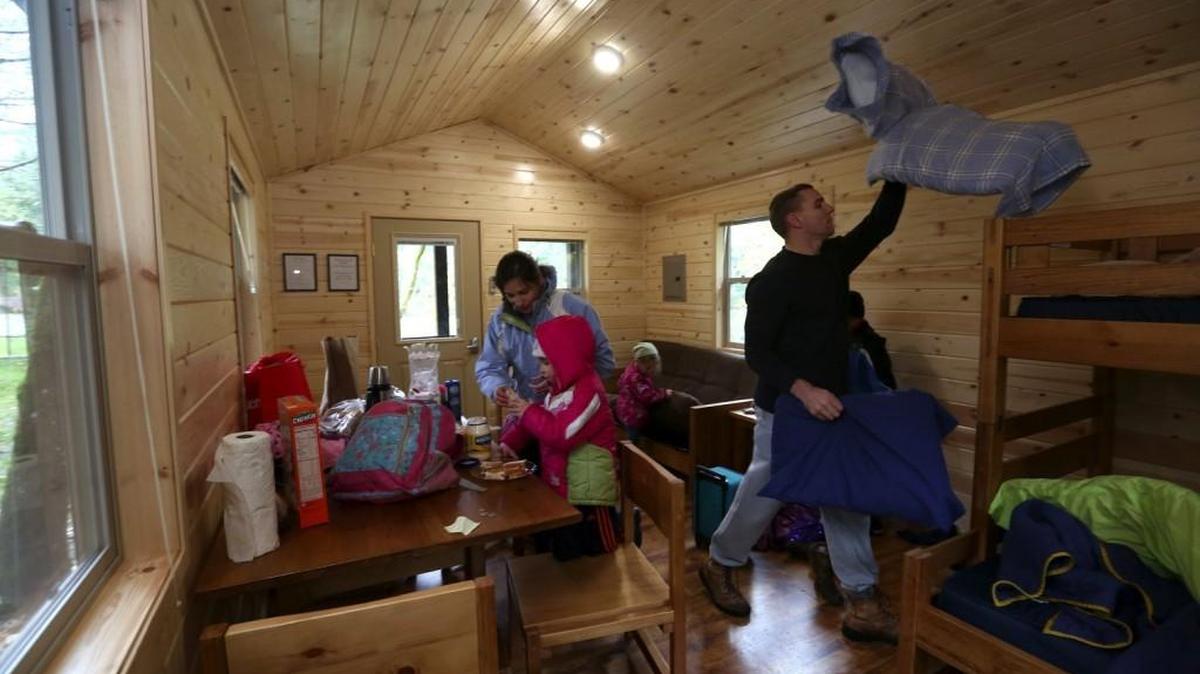 Julianne and David Thompson move with their four children into a cabin they rented at Dash Point State Park in Federal Way. The Thompsons, who live in Tacoma, are celebrating eight-year-old Simon’s birthday as well as just having a little family vacation.