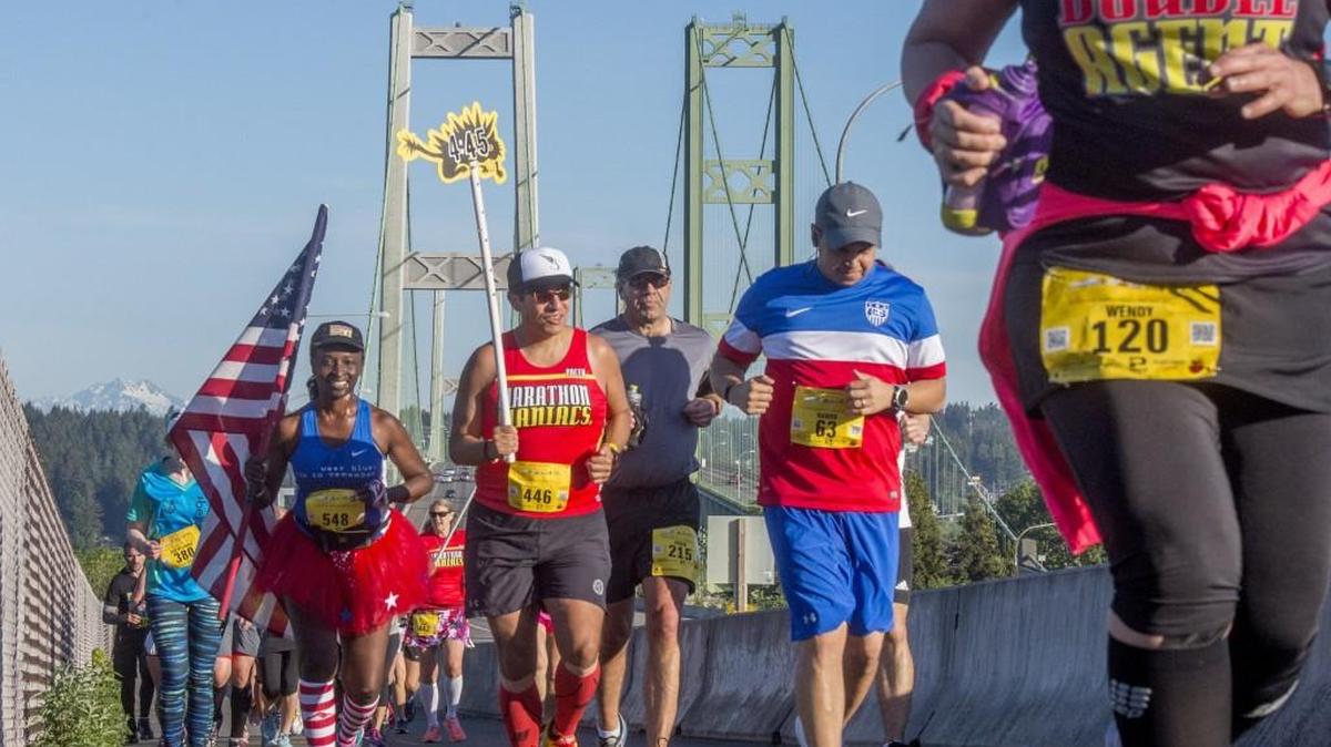 Runners climb the hill after crossing the Narrows Bridge in the Tacoma City Marathon on Sunday.