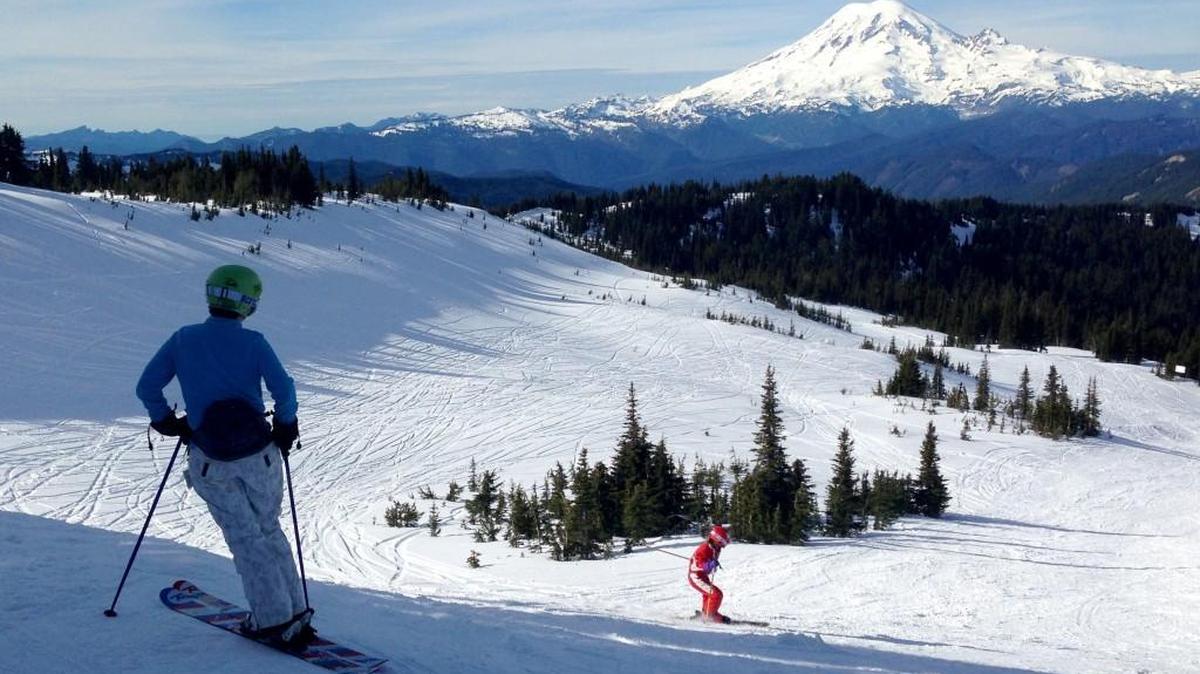 Rachel Emmons of Yakima watches Nora Emmons ski the Snow Devil run at White Pass in February.