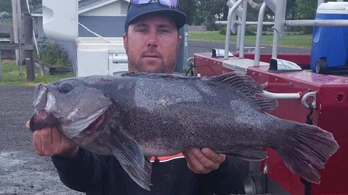 Steven Charles Orr of Rochester, Washington, holds the 10.72-pound black rockfish that is the new state record.