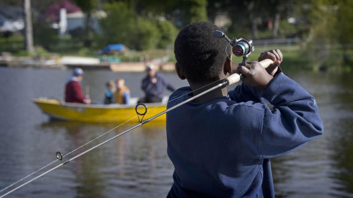 Anglers were fishing from docks, boats, shore and a variety of other watercraft when the lowland lake trout fishing season opened Saturday.