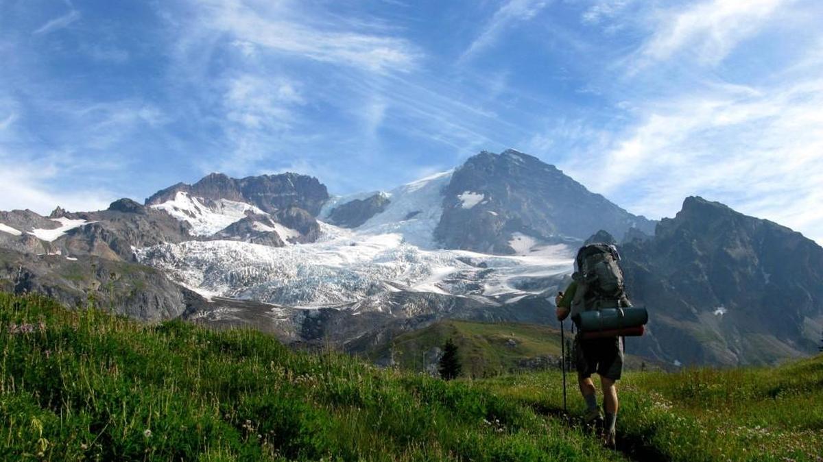A backpacker takes on the Wonderland Trail in 2012. The permit system is down this year, but park officials say the first-come, first-served system it’s forced to use this summer is working well.