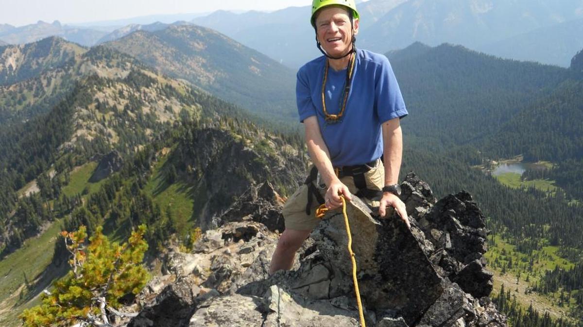 Mickey Eisenberg reaches the top of Three Way Peak in Mount Rainier National Park. Eisenberg and fellow climber Gene Yore wrote a guide to climbing in the park in 2013.