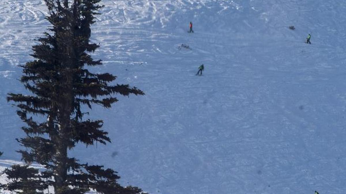 Skiers and boarders work their way down Green Valley below the mountaintop restaurant and gondola station at Crystal Mountain, December 1, 2014. Green Valley is expected to open Saturday.