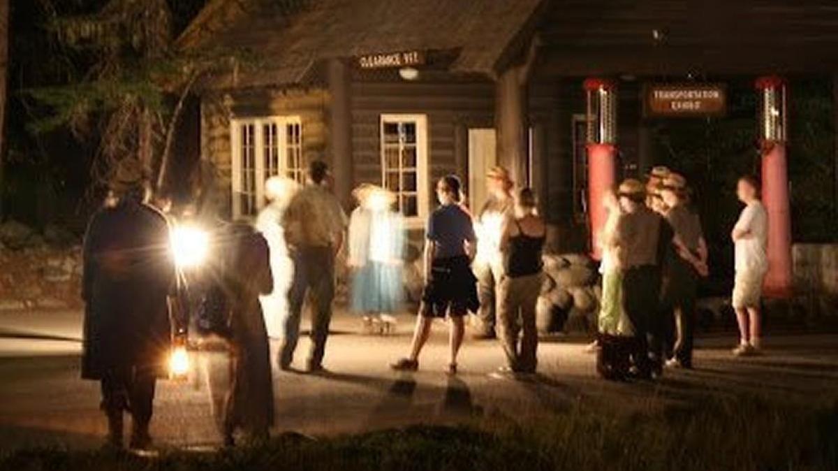 Park visitors prepare to follow a lantern-carrying guide during the Shadows of the Past program in 2104. In the program, actors portray key figures from the park’s early days. This year’s event will be Saturday.
