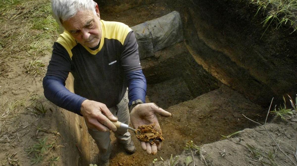 Archeologist Greg Burtchard shows a sample of ash from a Mount Saint Helens blast 3,500 years ago. Volcanic events create distinct layers, which archeologists use to help date human activity on Mount Rainier.