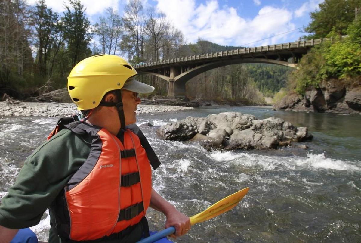 Rob Smith, northwest director of NPCA, approaches the Highway 101 bridge during a rafting tour of the Elwha River in 2014. This area was underwater as part of Lake Aldwell before the Elwha Dam was removed in 2012.