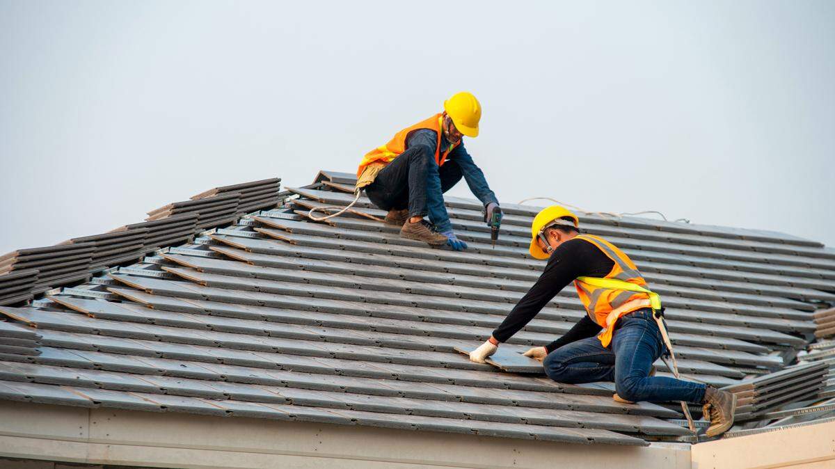 Roofers laying shingles
