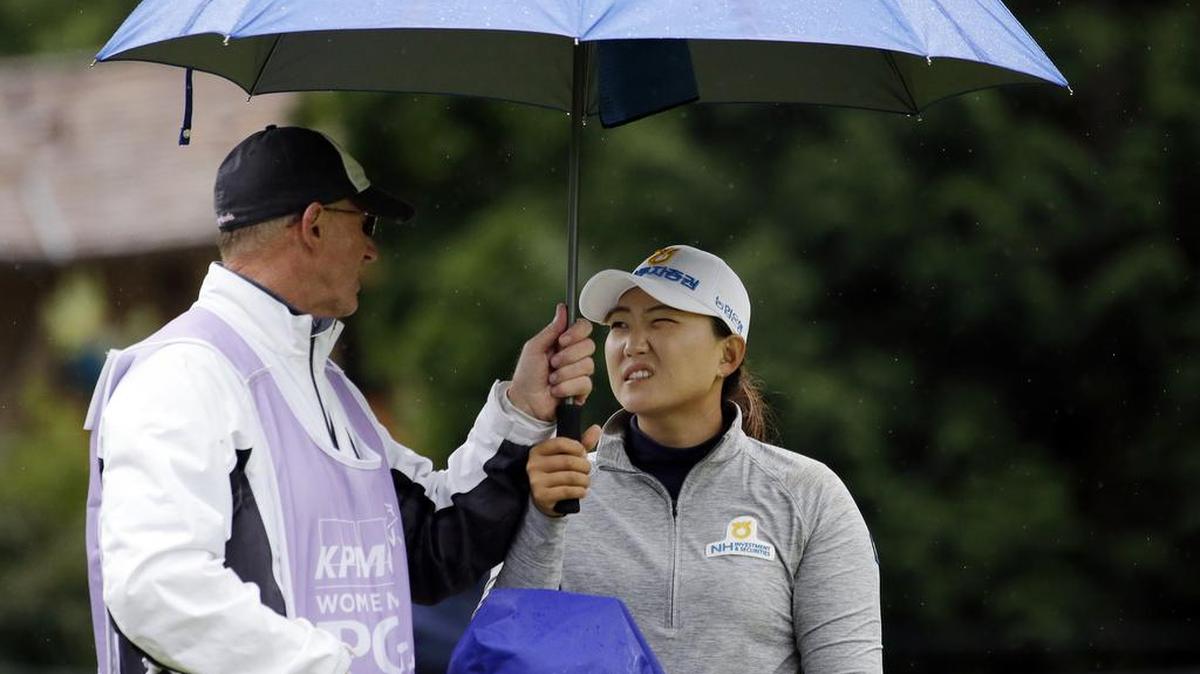 Mirim Lee, right, talks with caddie Daryl Smith on the seventh hole in the second round at the Women’s PGA Championship on Friday in Sammamish. Lee was tied for the lead with Brooke Henderson at 2-under par.