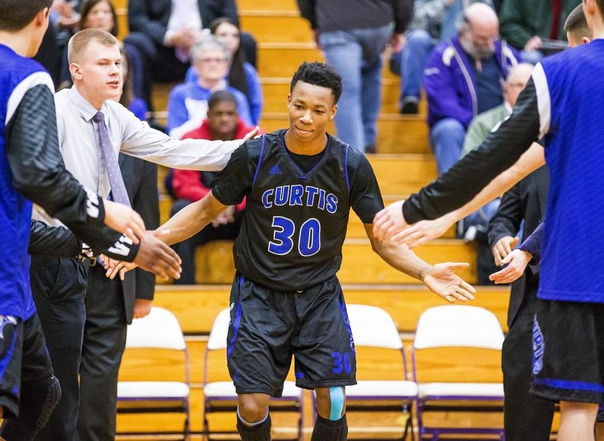 Curtis HS forward Semaj Booker is introduced at the start of a district playoff game with Federal Way.