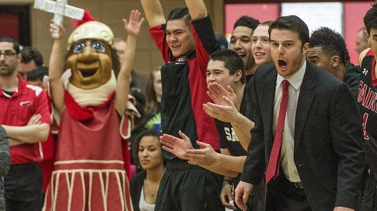 The SMU Saint's coach Alex Pribble, right and his bench react to a scouring run during the first half of a GNAC semifinal matchup between Saint Martin's University and Western Washington men's teams in Lacey on Friday, March 3, 2017.