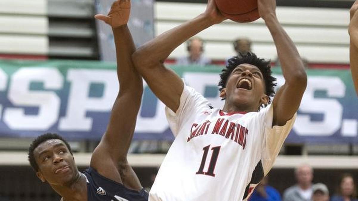 Saint Martin's guard Jordan Kitchen powers to the basket against Concordia defender Christopher Edward during their quarterfinal game of GNAC basketball championship tournament at Saint Martin's University in Lacey on Thursday, March 2, 2017.