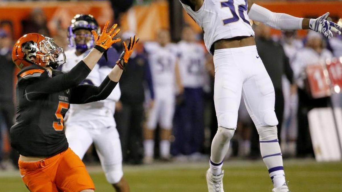 Washington defensive back Budda Baker (32) intercepts a pass intended for Oklahoma State wide receiver Blake Webb (5) during the first half of the Cactus Bowl last season.