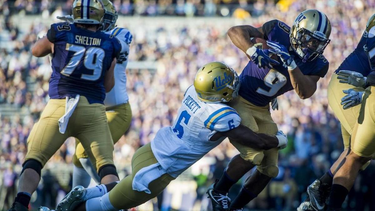 Washington running back Myles Gaskin fights off a tackle during a touchdown run in the third quarter against UCLA. Gaskin ran for 169 yards as the Huskies torched the Bruins for over 300 yards rushing.