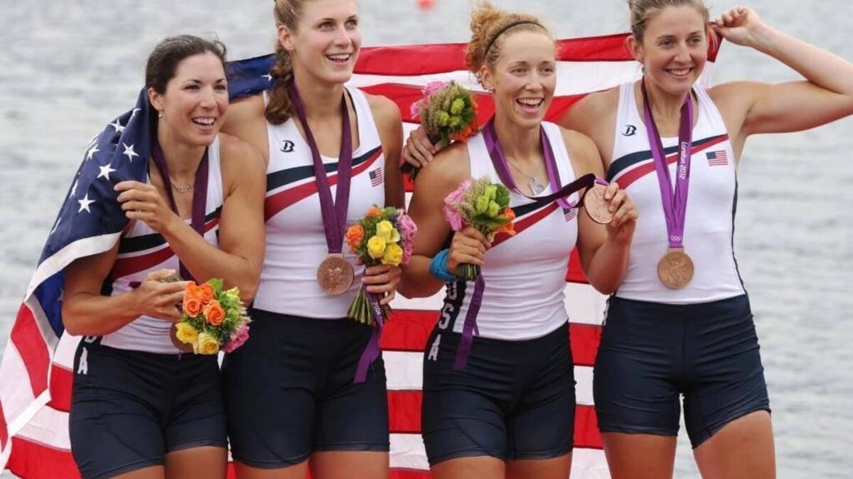 U.S. rowers, from left, Adrienne Martelli, Megan Kalmoe, Kara Kohler, and Natalie Dell display the bronze medals they won in the women's rowing quadruple sculls at the 2012 London Olympics. Martelli is one of 12 U.S. rowers returning to compete in Rio.
