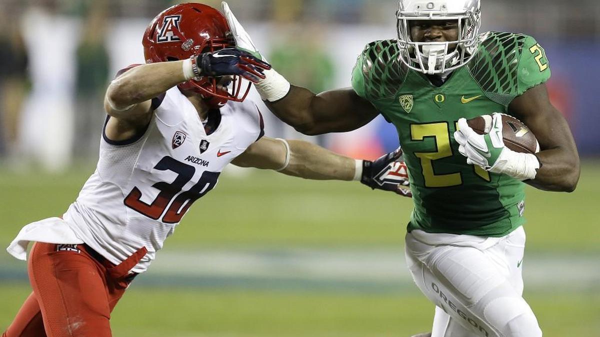 
Oregon running back Royce Freeman, right, evades Arizona's Jared Tevis during the Pac-12 Championship on Dec. 5. Just a sophomore, Freeman is already assuming a leadership role.
