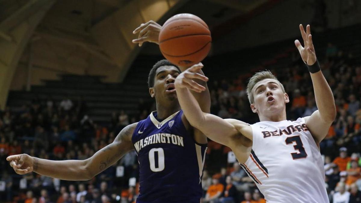 Washington's Marquese Chriss, left, and Oregon State's Tres Tinkle vie for a rebound during the first half of an NCAA college basketball game in Corvallis, Ore., on Wednesday, Feb. 24, 2016.