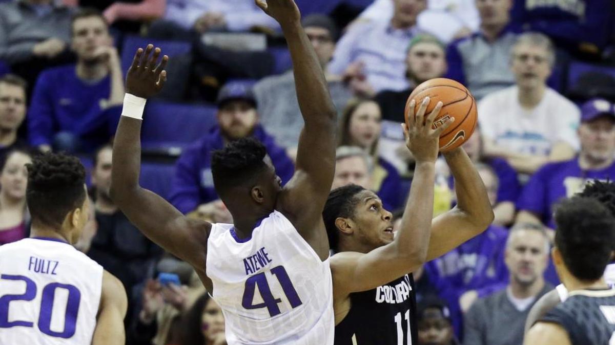 Colorado’s Xavier Johnson (11) puts up a shot in front of Washington’s Matthew Atewe (41) on Jan. 18 in Seattle. Johnson scored 24 points against the Huskies that night.