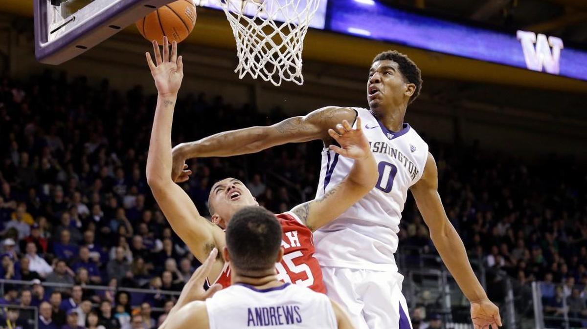 Washington's Marquese Chriss (0) blocks a shot by Utah's Kyle Kuzma in the first half on Sunday in Seattle. Chriss scored 15 points but fouled out with a minute left in regulation.