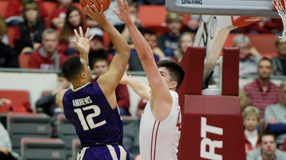 Washington’s Andrew Andrews (12) shoots over the hands of Washington State’s Conor Clifford in the first half Saturday. Andrews finished with a game-high 29 points.