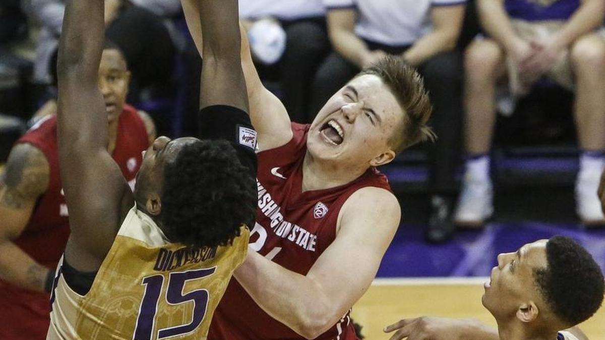 University of Washington forward Noah Dickerson (15) and Washington State forward Josh Hawkinson (24) fight for a rebound in the second half in the first meeting of the season between the Huskies and Cougars on Jan. 1. WSU would rally back to win the game, 79-74.