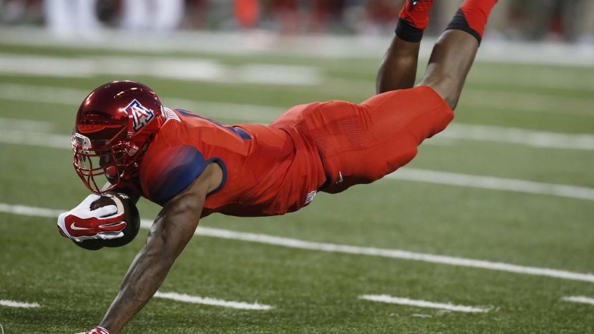 Arizona quarterback Jerrard Randall (8) scores a touchdown against UCLA during the first half of an NCAA college football game, Saturday, Sept. 26, 2015, in Tucson, Ariz.