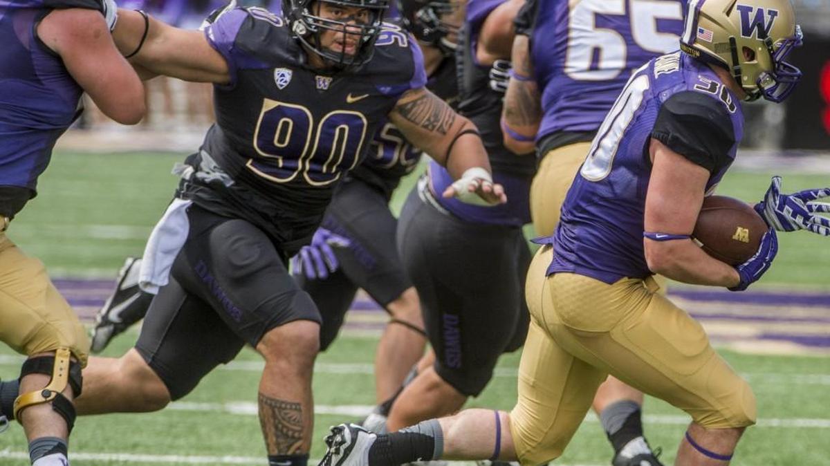 
Defensive lineman Taniela Tupou (90), chasing ball carrier Gavin McDaniel (right) during spring football practice in April, has earned the respect of his teammates through perseverance. 

