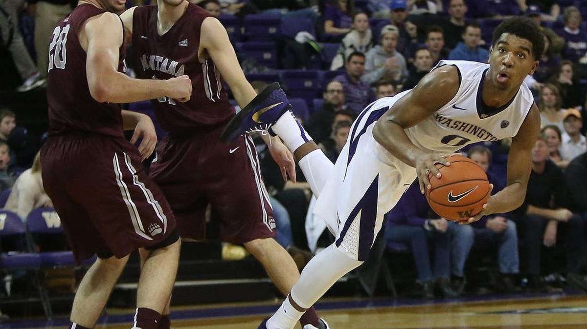 UW’s Marquese Chriss (0) falls to the court after plowing through a double team by Montana’s Fabijan Krslovic (20) and Jack Lopez. At one point, Chriss drew a technical after an alley-oop dunk, but said “we were just having fun.”