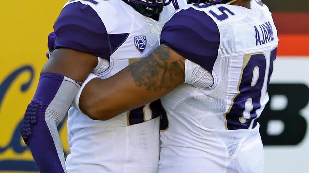 
The Huskies lost tight end David Ajamu, right, for the season after he suffered a knee injury in warm-ups. 
