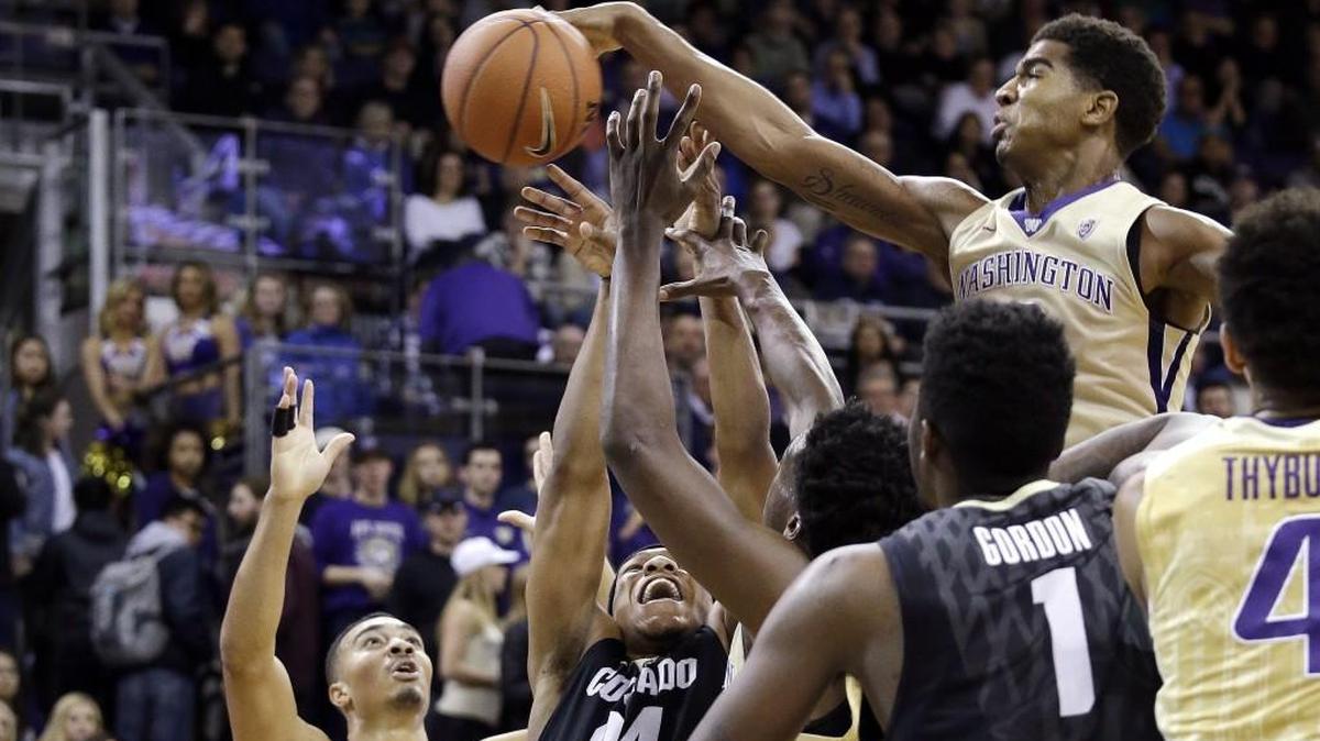 Washington's Marquese Chriss, right, leaps above the crowd to knock the ball away from Colorado's George King (24) in the first half of an NCAA college basketball game Wednesday, Jan. 20, 2016, in Seattle.
