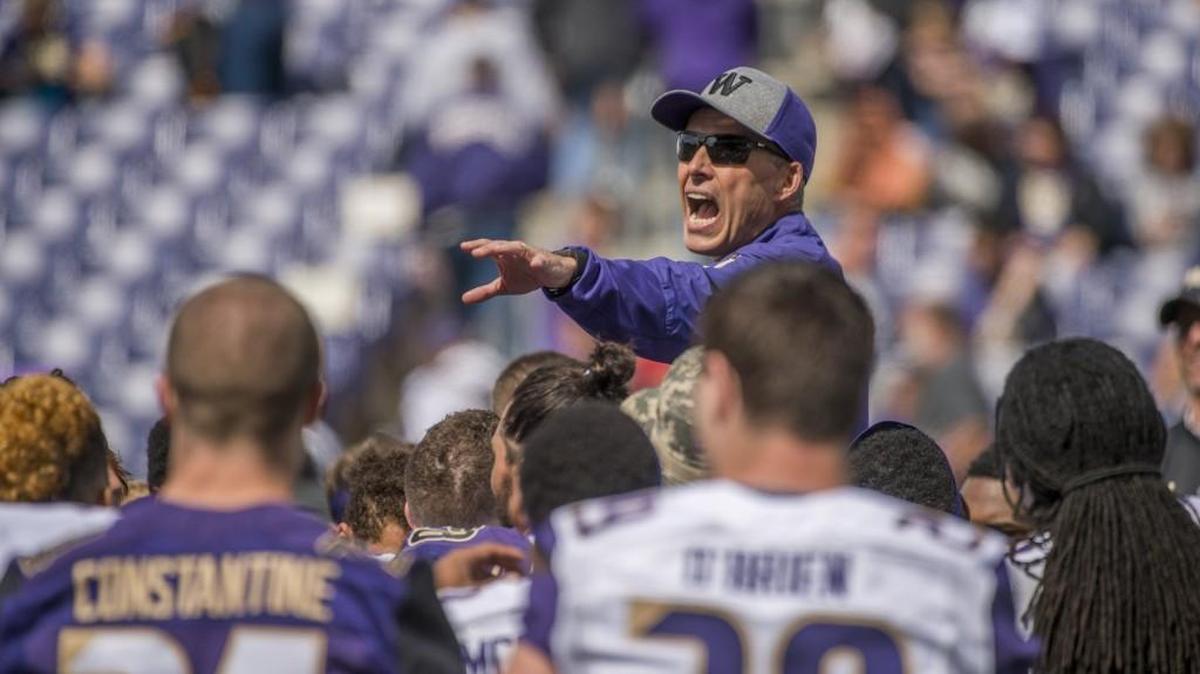 Huskies coach Chris Petersen addresses the team the end of the University of Washington Huskies annual spring football preview at Husky Stadium, April 23, 2016.