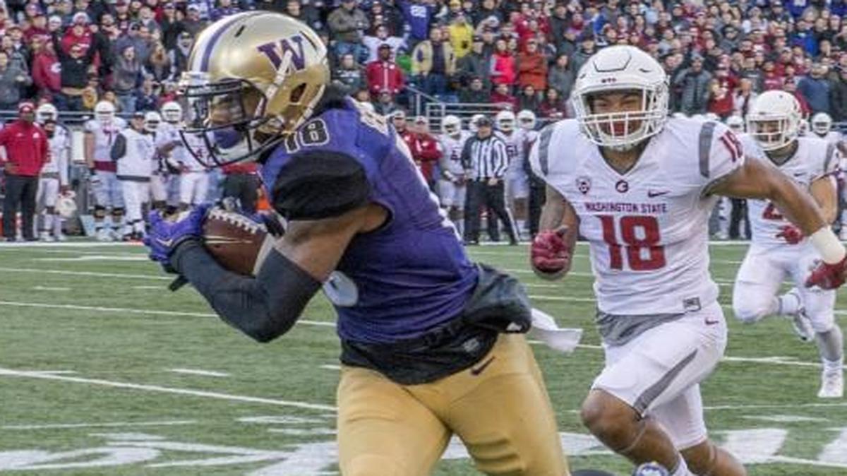 Washington's Isaiah Renfro heads for the end zone with a pass he caught in the first half of the Apple Cup on November 27, 2015, in Husky Stadium.