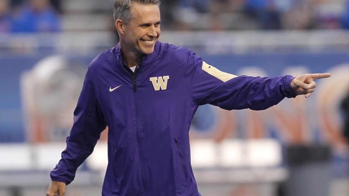 
Washington coach Chris Petersen smiles as players warm up for an NCAA college football game against Boise State in Boise, Idaho, on Friday, Sept. 4, 2015.
