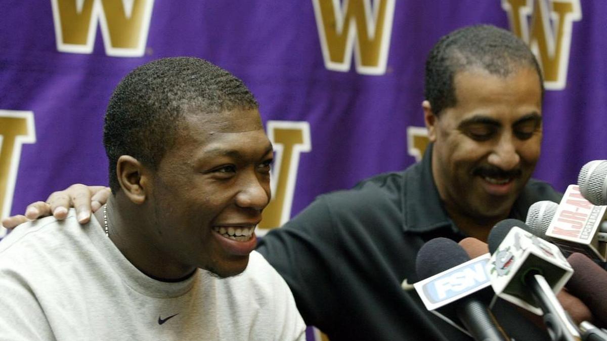 Washington guard Nate Robinson, left, talks to reporters along with Washington basketball coach Lorenzo Romar, in Seattle, Monday, April 11, 2005.