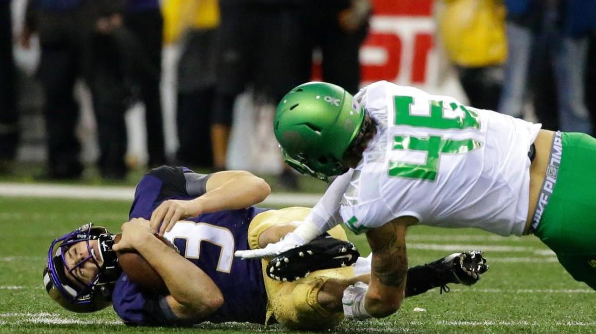 
Washington quarterback Jake Browning (3) goes down on a keeper play as Oregon linebacker Danny Mattingly (46) pursues in the first half of an NCAA college football game, Saturday, Oct. 17, 2015, in Seattle.
