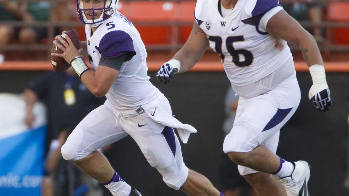 
Washington offensive lineman Dexter Charles (76), shown blocking for quarterback Jeff Lindquist during the 2014 season opener at Hawaii, was forced to retire because of a knee injury. Charles was the Huskies’ most experienced offensive lineman, starting 30 games.

