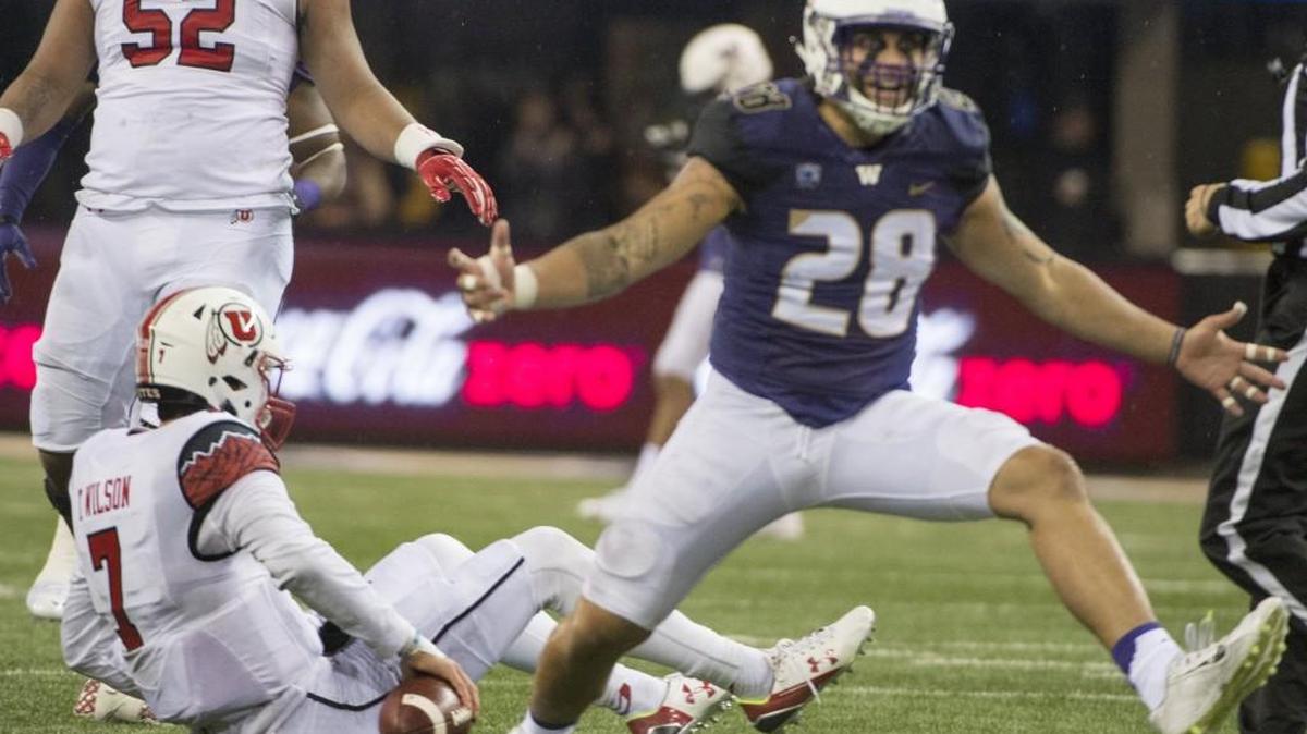 Washington linebacker Psalm Wooching celebrates a sack of Utah quarterback Travis Wilson on Nov. 7 during the fourth quarter. Wooching has earned more playing time as UW’s buck linebacker behind starter Travis Feeney.