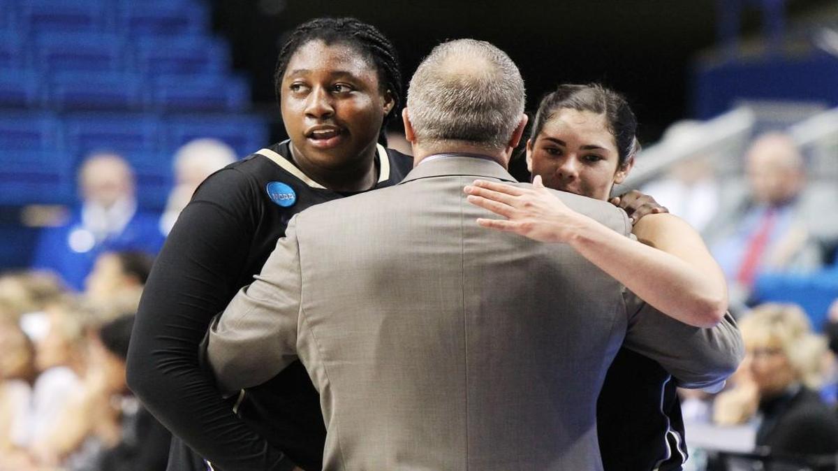 From Left, Washington’s Chantel Osahor, coach Mike Neighbors and Kelsey Plum hug in the closing moments of Sunday’s regional final against Stanford in Lexington, Ky. Washington won, 85-76.