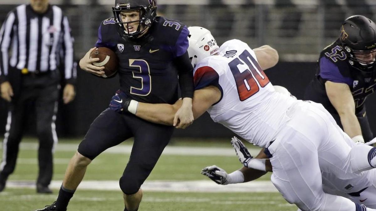 Washington quarterback Jake Browning (3) carries the ball as Arizona defensive lineman Luca Bruno (60) tackles him in the first half an NCAA college football game Saturday, Oct. 31, 2015, in Seattle.