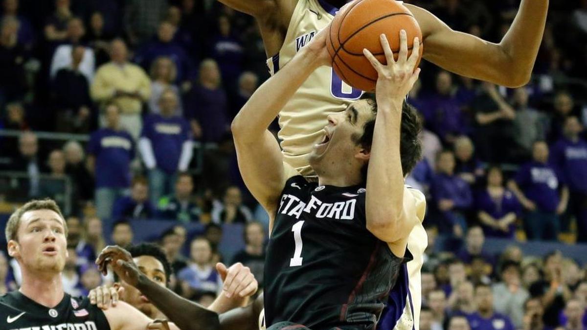 UW forward Marquese Chriss, top, tries to block Stanford guard Christian Sanders (1) during the Huskies’ 64-53 win Feb. 20 over the Cardinal. UW plays Stanford in the first round of Pac-12 tournament Wednesday.