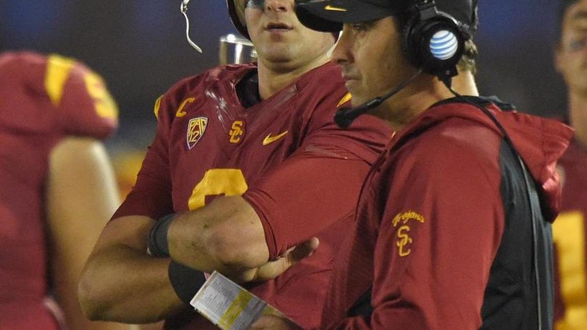
Southern California head coach Steve Sarkisian, right, watches the action next to quarterback Cody Kessler in 2014. Sarkisian coached the Washington Huskies from 2009-2013.
