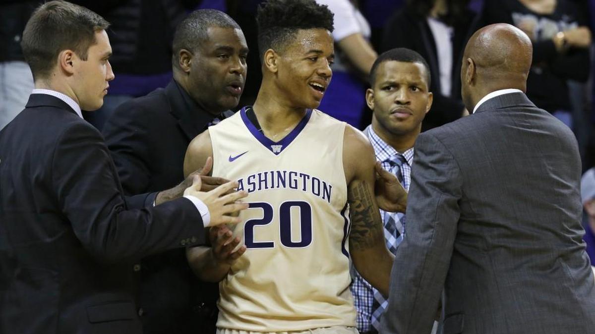 Washington guard Markelle Fultz is greeted by coach Lorenzo Romar, right, and other team personnel late in the second half of the team's NCAA basketball game against Cal State Fullerton in November.