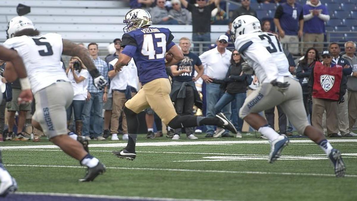 
Huskies kicker Tristan Vizcaino scampers in for a touchdown on a fake field goal attempt Saturday at Husky Stadium. It was the first fake field goal touchdown by a place kicker since at least 1974.
