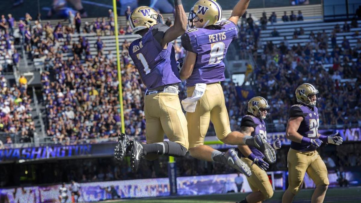 UW’s John Ross, left, and Dante Pettis celebrate after Pettis scored a touchdown against Idaho on Saturday at Husky Stadium. Pettis finished with two scoring receptions: a 21-yarder early in the first quarter and a 7-yarder early in the second quarter.