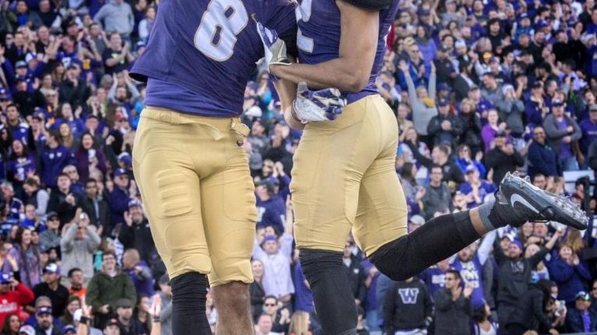 Huskies receiver Dante Pettis (8) celebrates catching one of his two touchdown receptions with teammate Aaron Fuller at Husky Stadium on Oct. 22. Washington was named No. 4 in the College Football Playoff rankings on Tuesday.